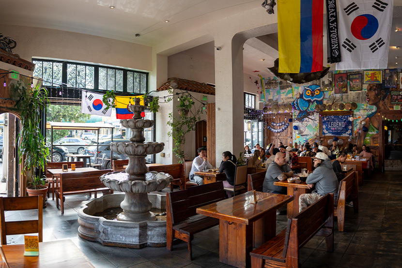 Inside EscaLa in Koreatown, with Colombian and Korean flags above the dining room